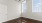 a room with a wood floor and windows