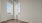 a room with a wood floor and a window with a wood floor