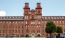 a tall bricked building with a parking lot