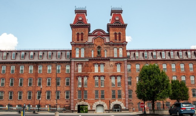 a tall bricked building with a parking lot