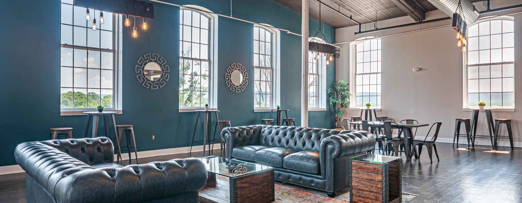 a room with a couch and chairs