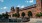 a large brick building with a parking lot in front of it