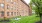 a brick building with a green lawn